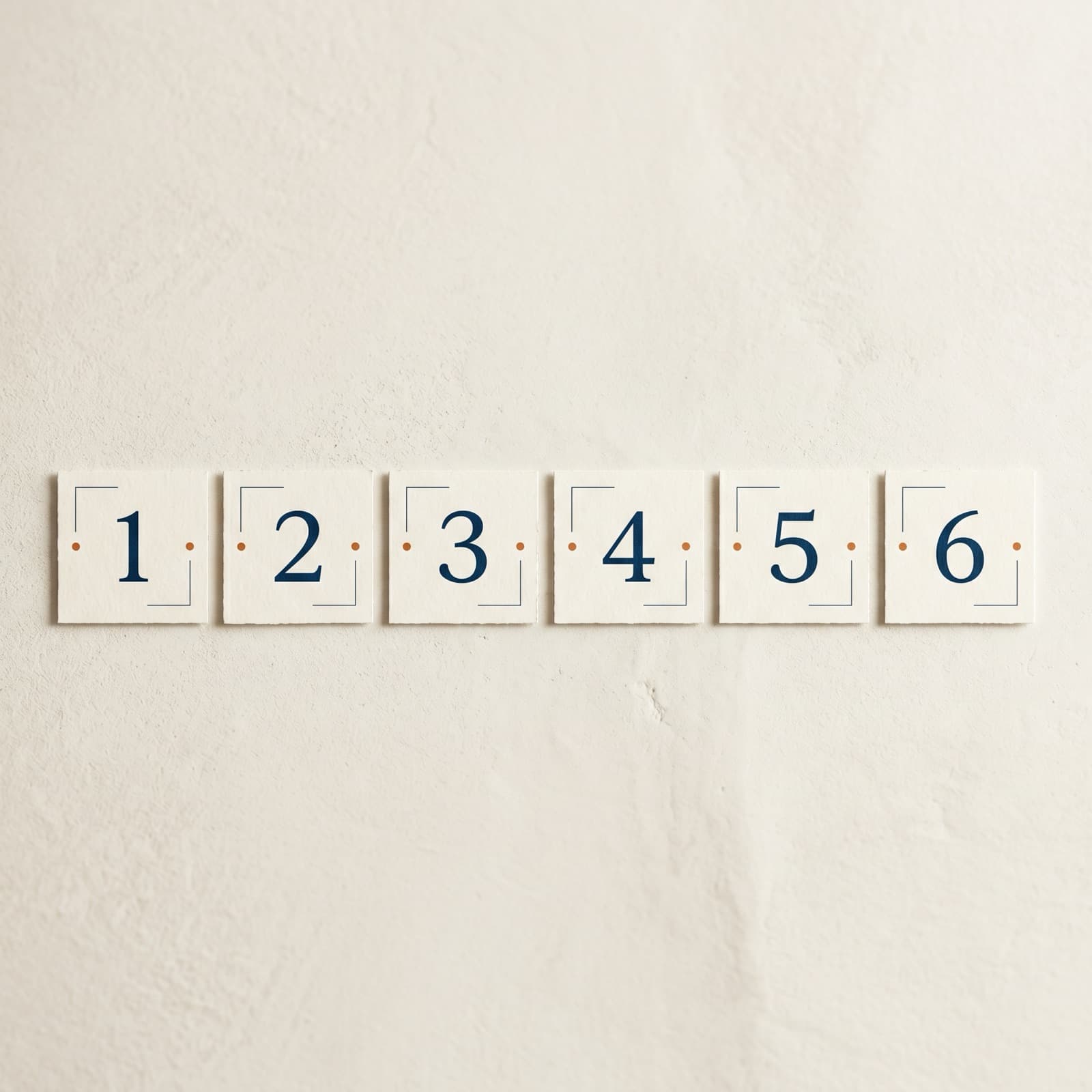 Overhead flat lay of six small numbered paper cards arranged as a quality-control gate on a warm off-white Nordic surface.